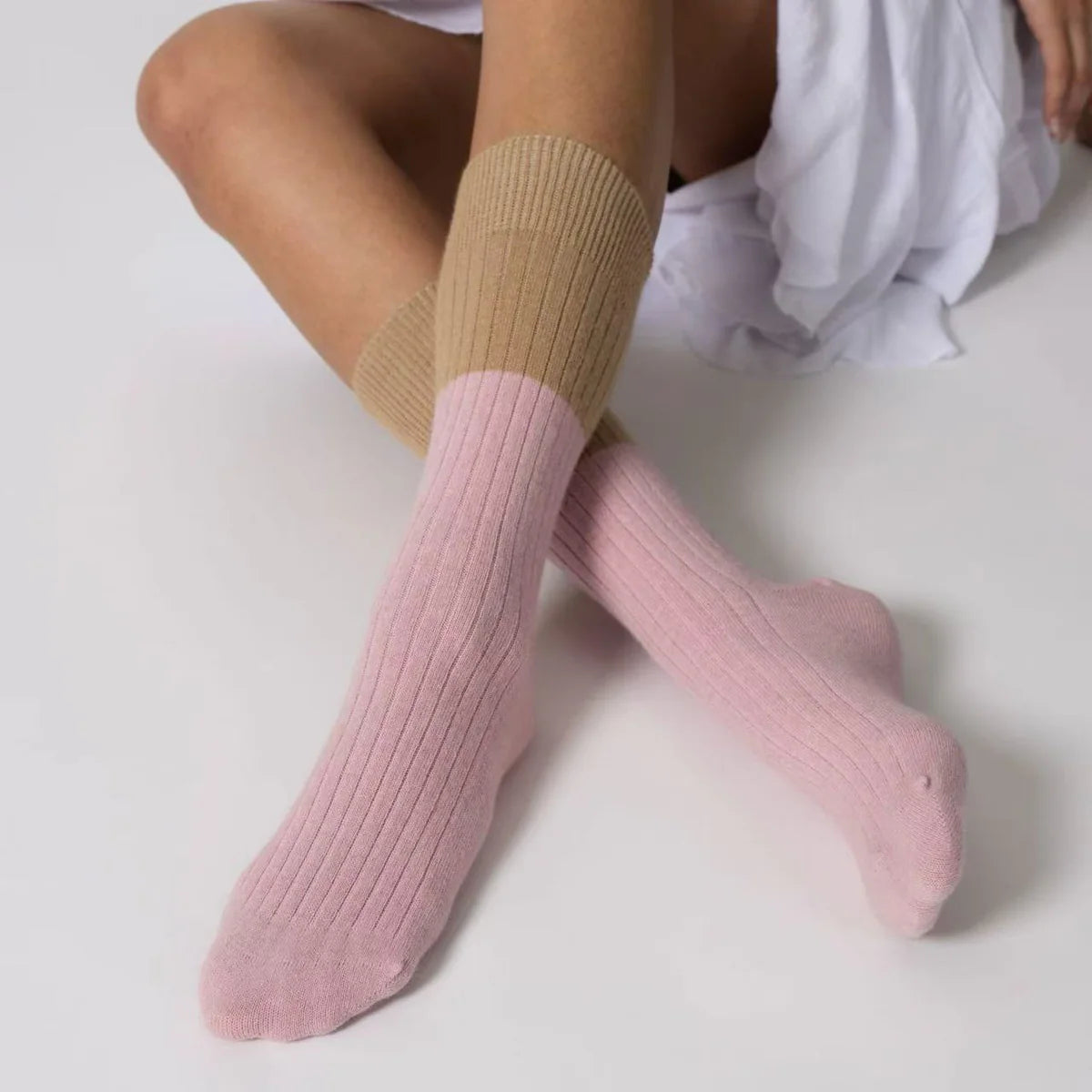 Possum merino stripe socks in rose water and beige worn on feet