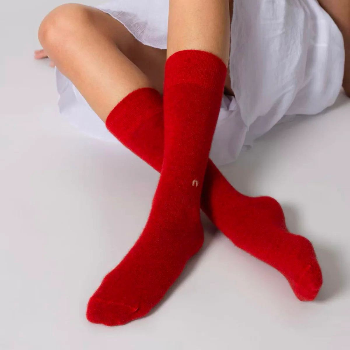 Possum merino wool socks in scarlet red worn on feet