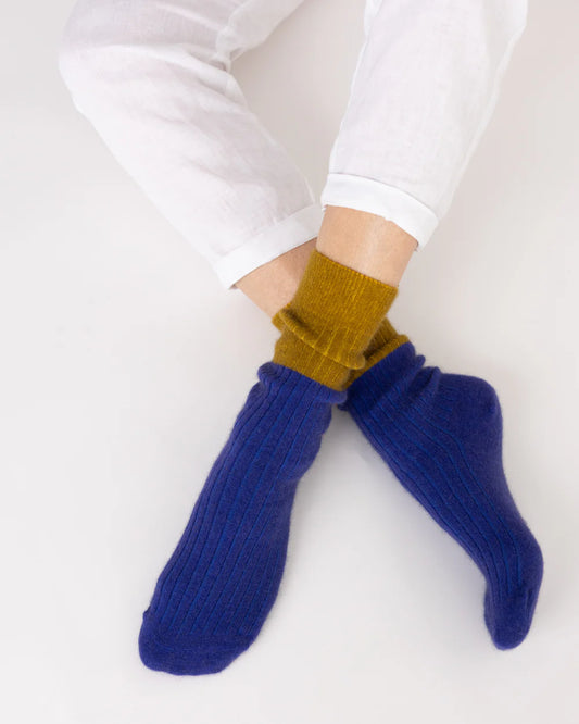 Possum merino stripe socks in royal blue and olive worn on feet