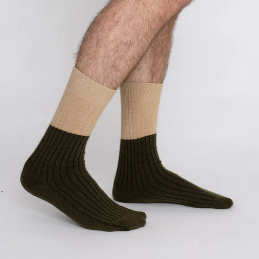 Possum merino stripe socks in military olive and beige worn on feet
