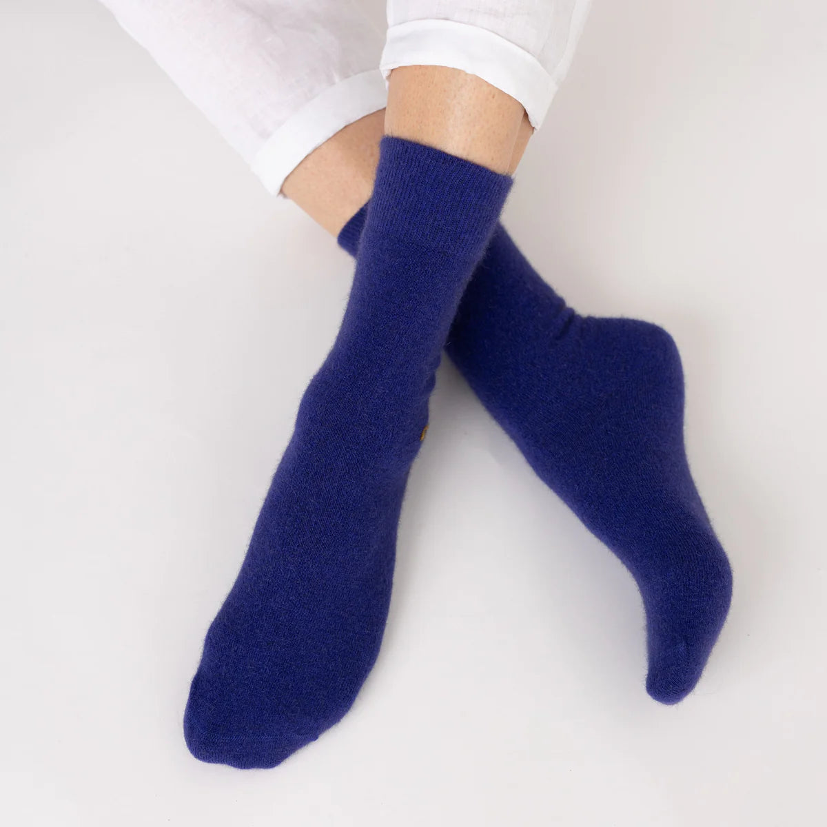 Possum merino wool socks in royal blue worn on feet