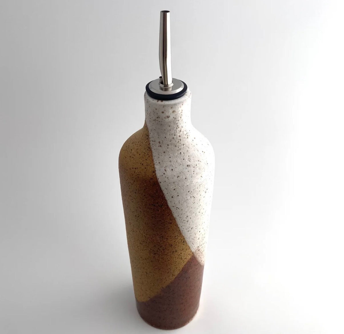 Handmade speckled stoneware olive oil vessel with desert landscape glaze