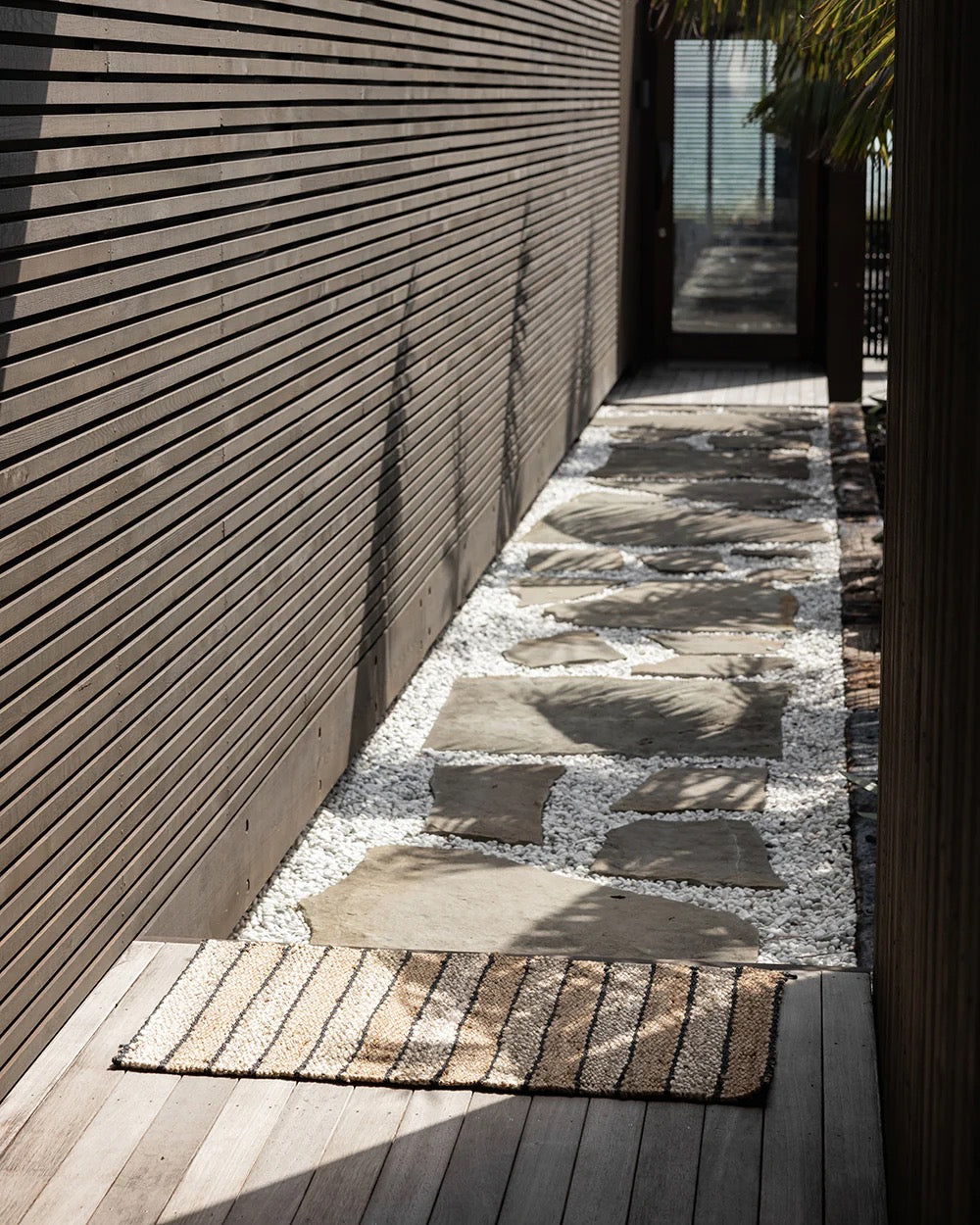 Multi-colour jute entrance door mat at a modern home entryway